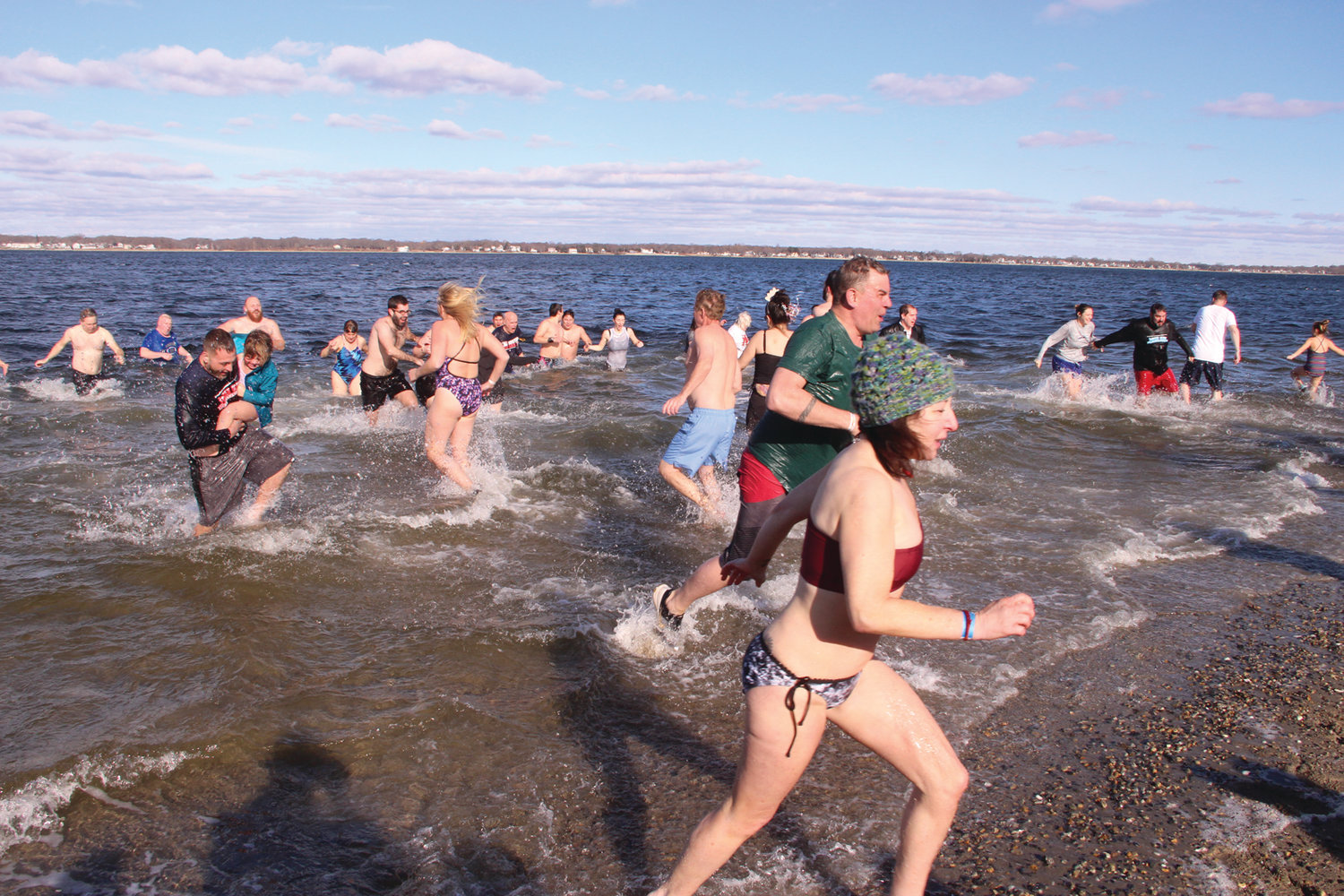 IN AND OUT: As quickly as participants raced into the water, those who preceded them ran to get out.